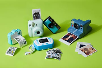 collection of instant cameras and digital cameras on a vibrant green surface, for a good housekeeping story on the best cameras for kids