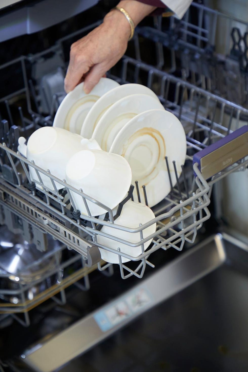 best dishwasher tablets loading dirty dishes into a dishwasher