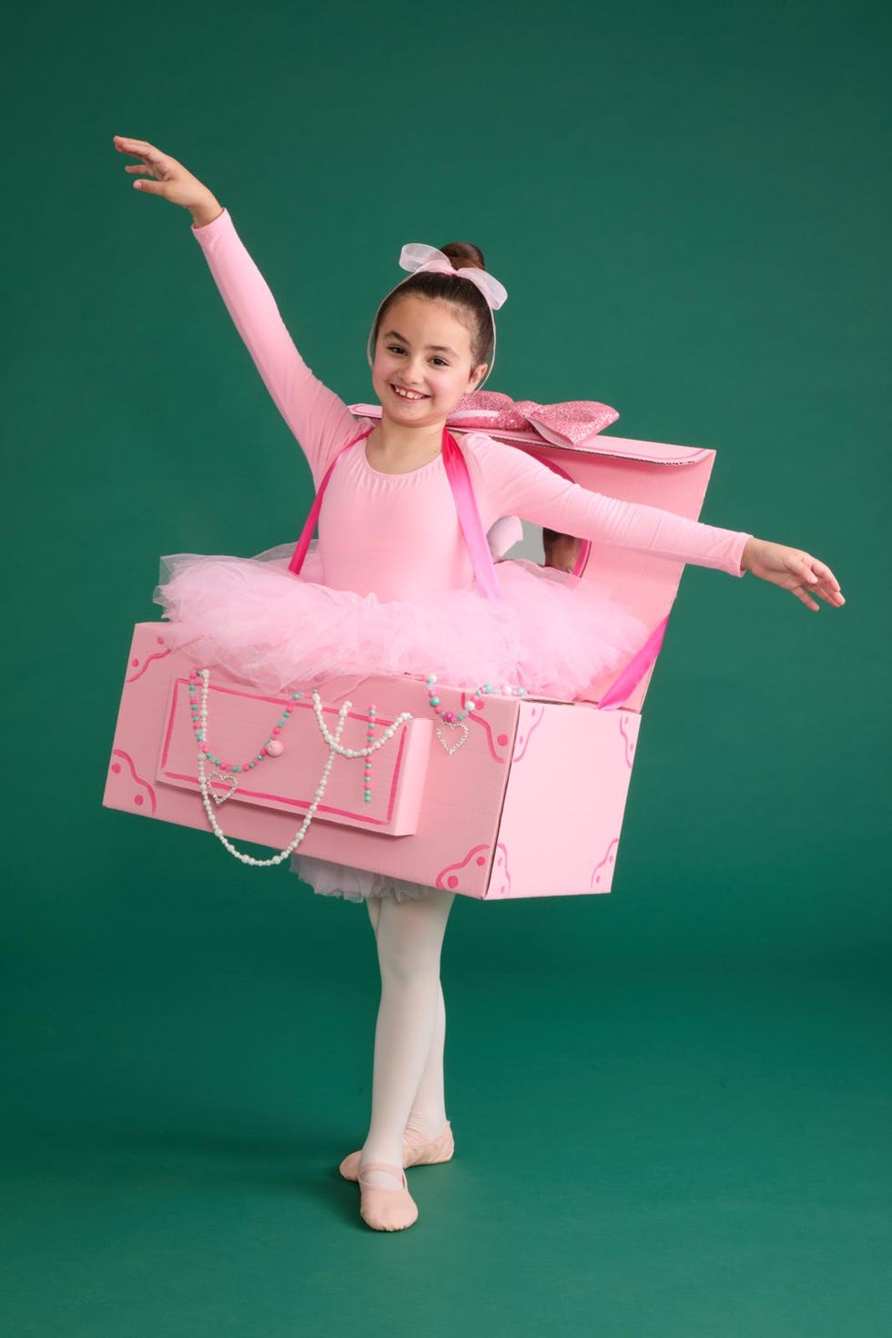 ballet dancer dressed as a large pink gift box