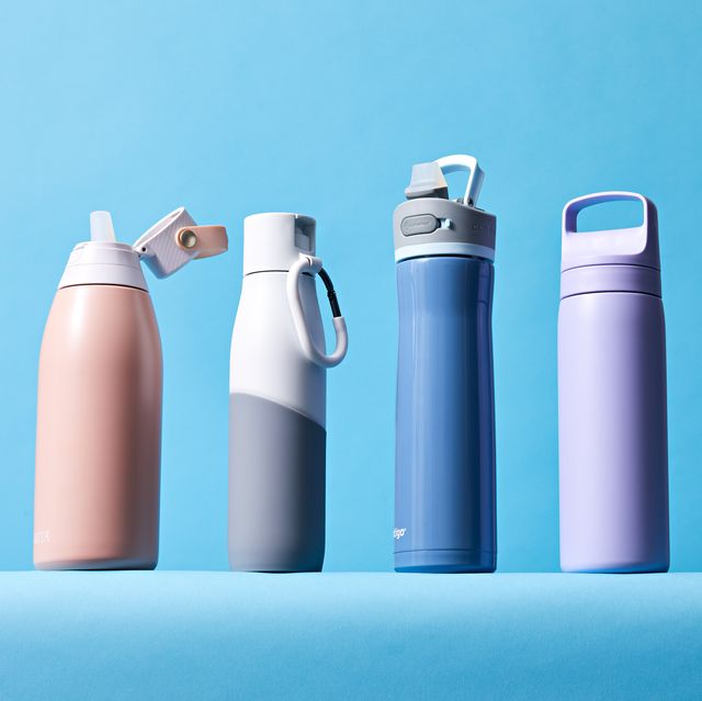 four water bottles standing in a row on a blue background