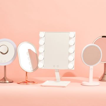 five vanity mirrors with lights on a pink background, good housekeeping's picks for the best vanity mirrors with lights