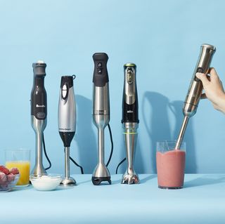 a hand hold an immersion blenders to blend a pink smoothie as part of a lineup of the immersion blenders tested by the good housekeeping institute