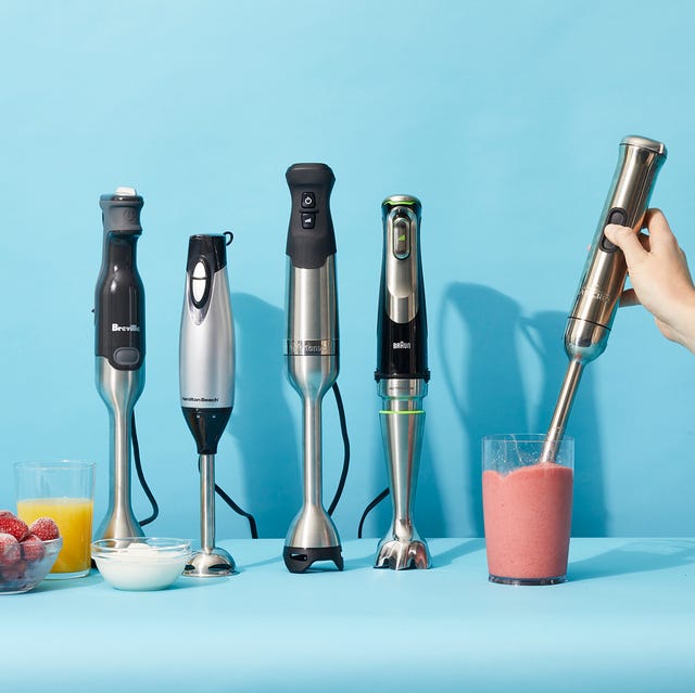 a hand hold an immersion blenders to blend a pink smoothie as part of a lineup of the immersion blenders tested by the good housekeeping institute