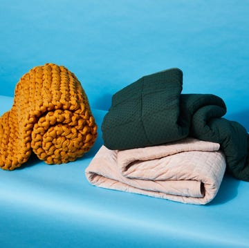 three weighted blankets against a blue background