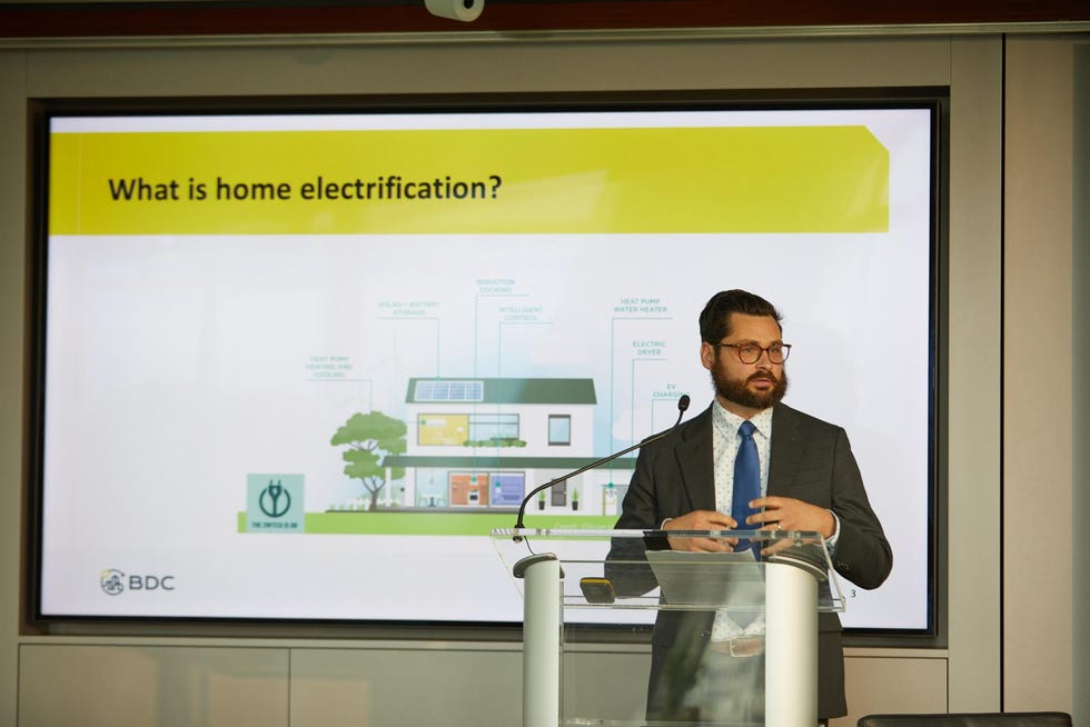 speaker matt castle in front of a powerpoint slide about home electrification