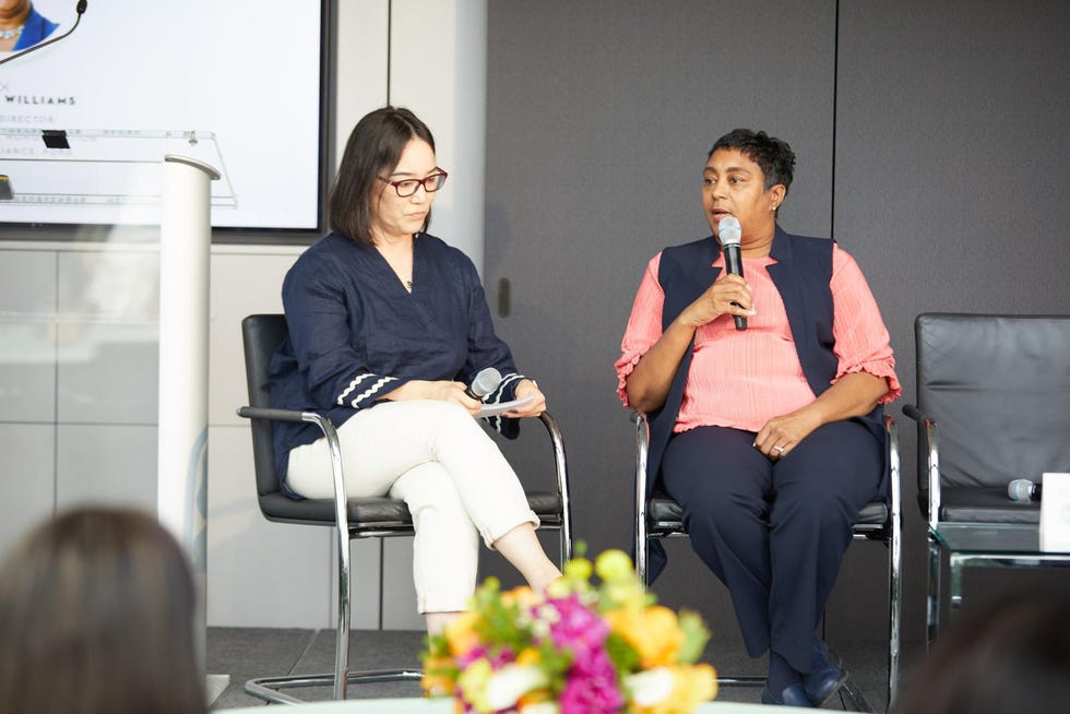 speakers cynthia williams and natalie neff speaking seated in front of a powerpoint presentation