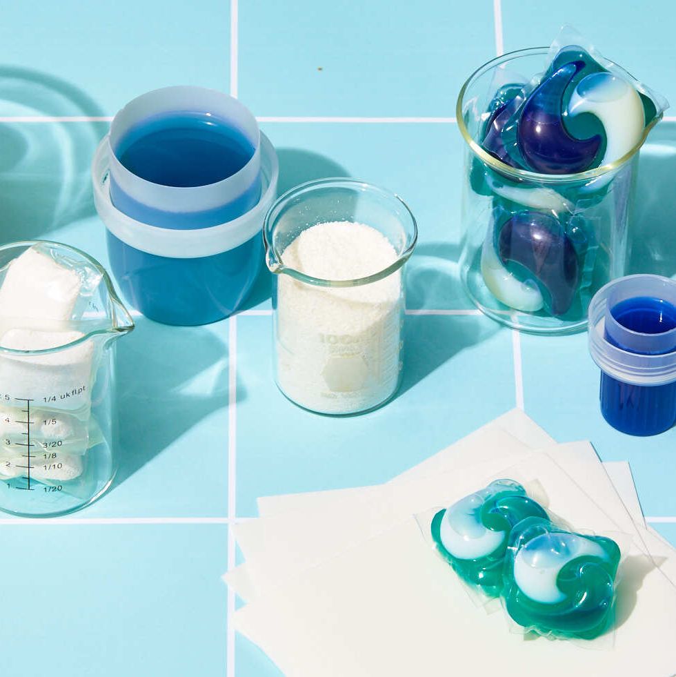 Laundry detergent or washing powder in blue measuring cup studio