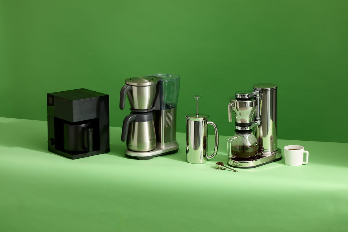 three coffee makers on a green background