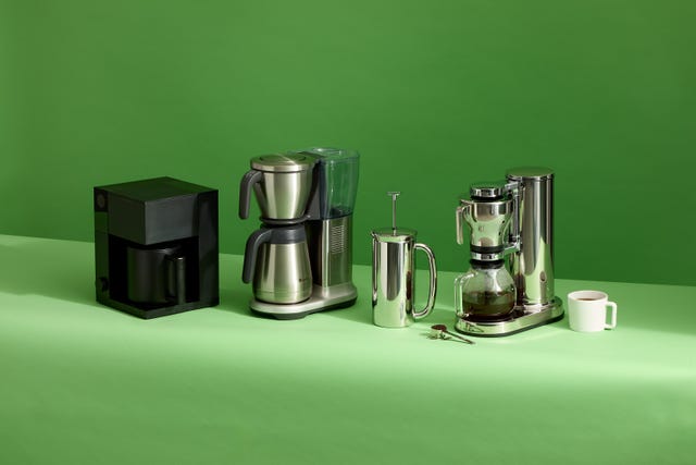three coffee makers on a green background