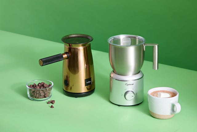two hot chocolate makers with chocolate chips and a cup of cocoa