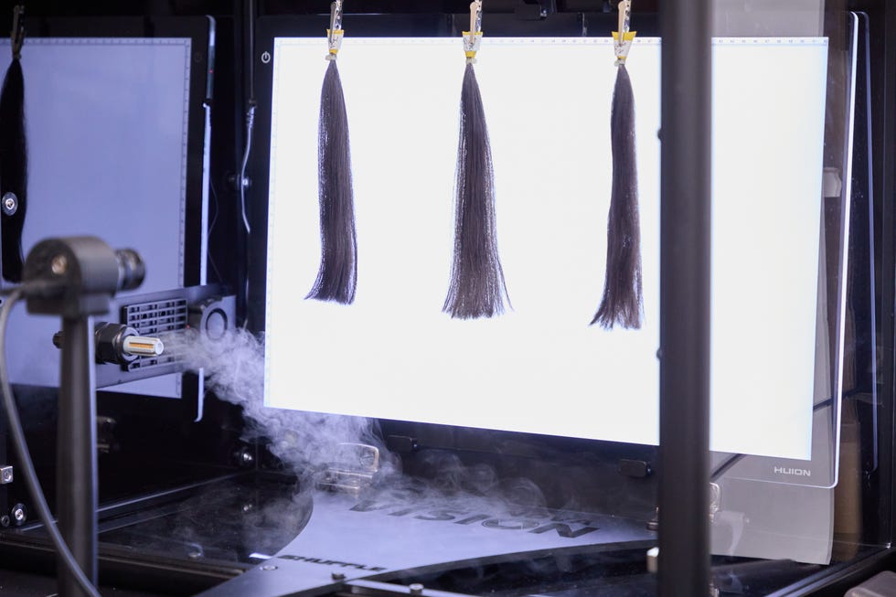 a photo of hair swatches in the humidity chamber testing anti frizz products in the good housekeeping institute beauty lab