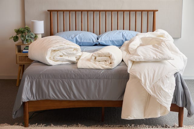 three cooling comforters on a bed, good housekeeping's best cooling comforters testing