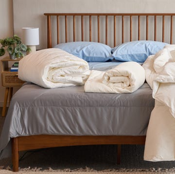 best cooling comforters - testing image three cooling comforters on a bed, good housekeeping's best cooling comforters testing