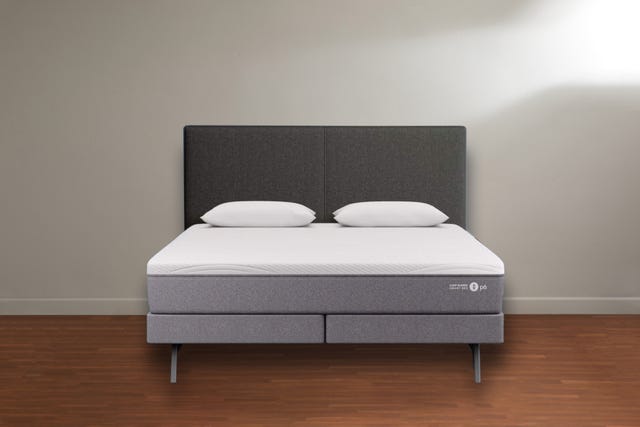 a sleep number p6 mattress on bed base, on wood floor against a white wall
