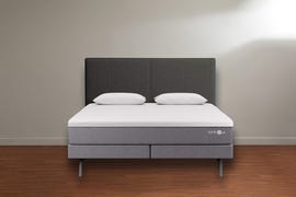 a sleep number p6 mattress on bed base, on wood floor against a white wall