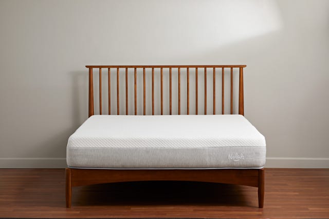 a white and gray nolah mattress on a wooden bed frame