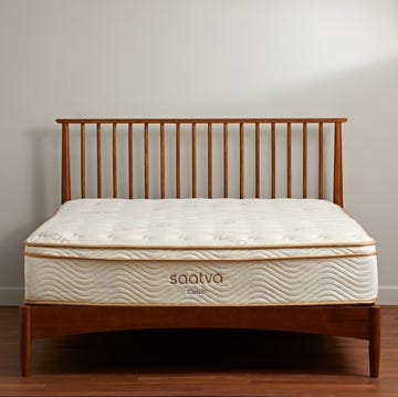 best mattress for side sleepers - saatva classic mattress a white and gold mattress from saatva on a bed frame