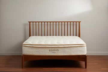 wooden bed frame with a mattress from saatva