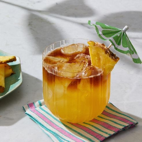mai tai with pineapple and beach umbrella as garnish