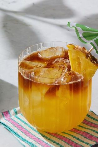  mai tai cocktail with pineapple and drink umbrella
