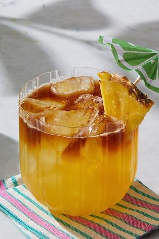  mai tai cocktail with pineapple and drink umbrella
