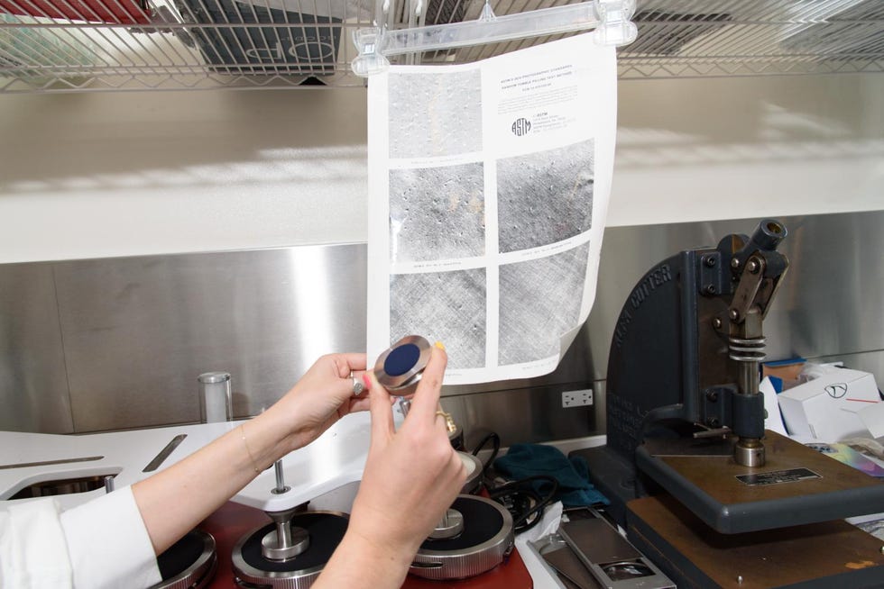 a textiles lab analyst observes a fabric swatch after 100 cycles on our abrasion tester to gauge pilling resistance
