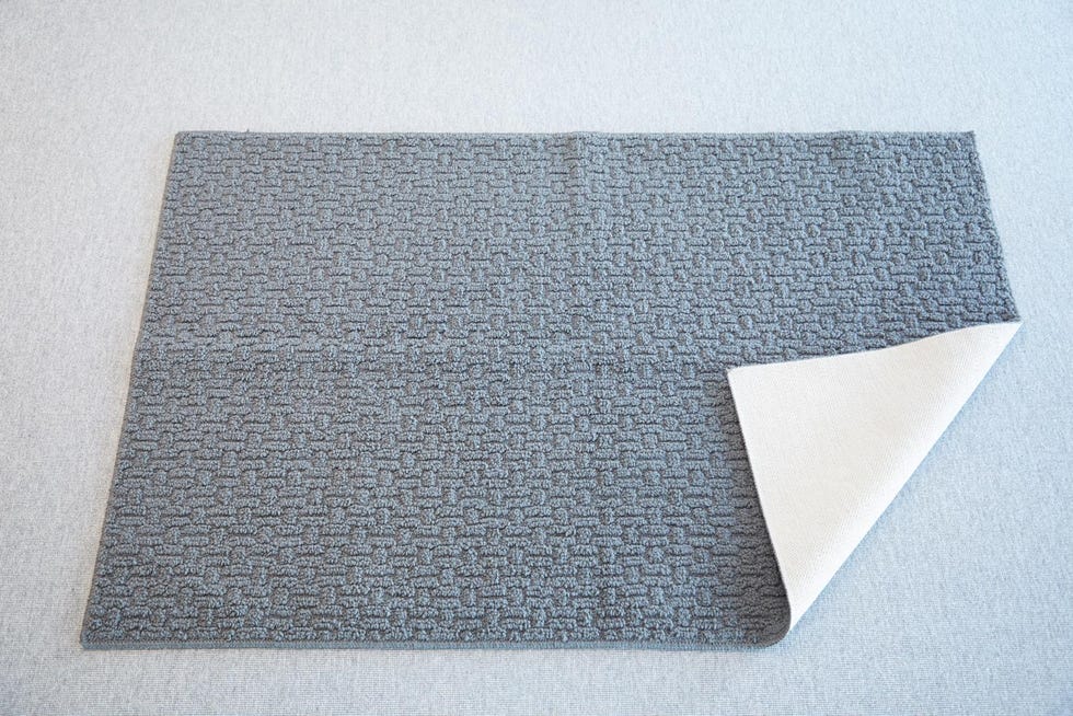 a grey washable rug from threshold folded at the corner