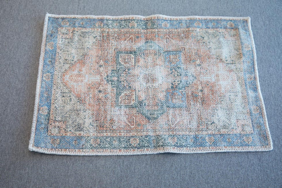 a close up shot of a red and blue patterned rug from boutique rugs