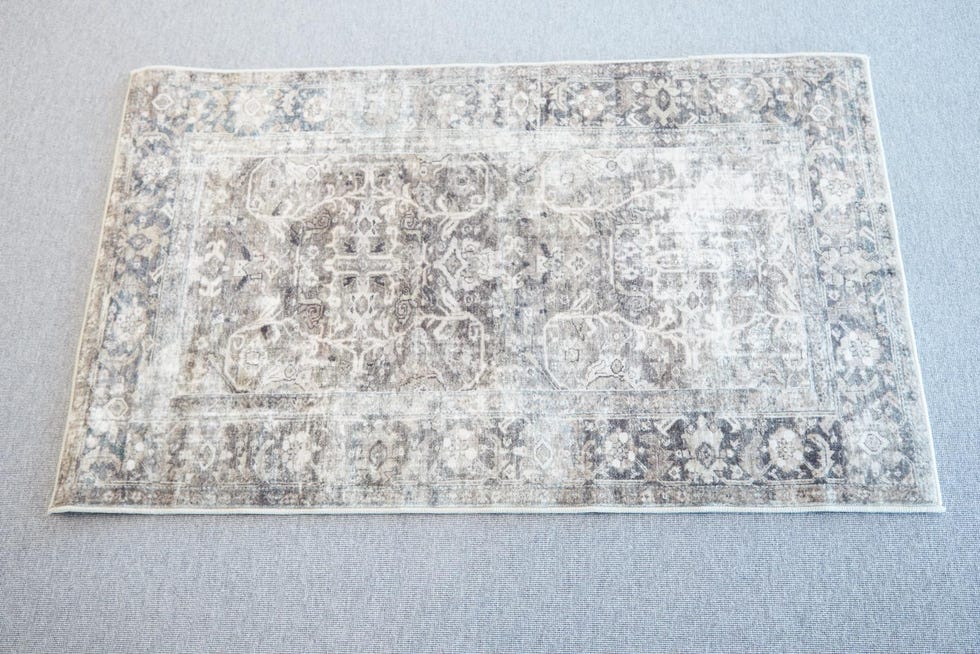 a grey and green patterned washable rug