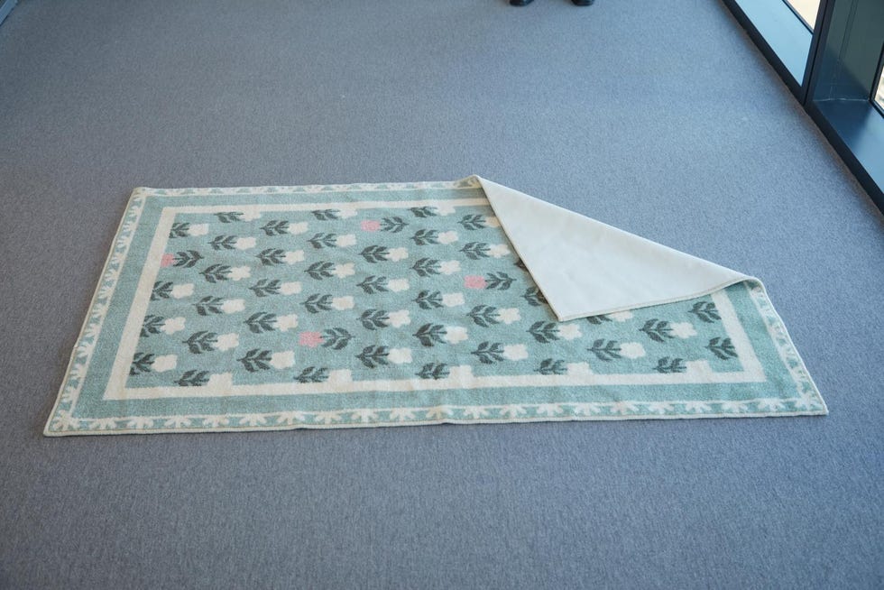 a green and pink floral rug from west elm