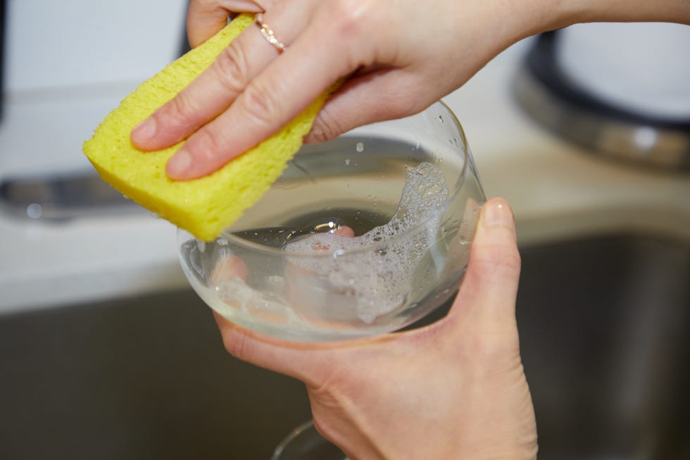 a person holding a clear container