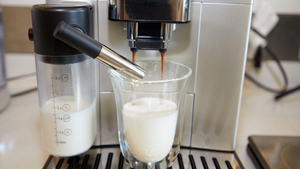 a glass of milk being poured into a glass of milk a glass of milk being poured into a glass of milk
