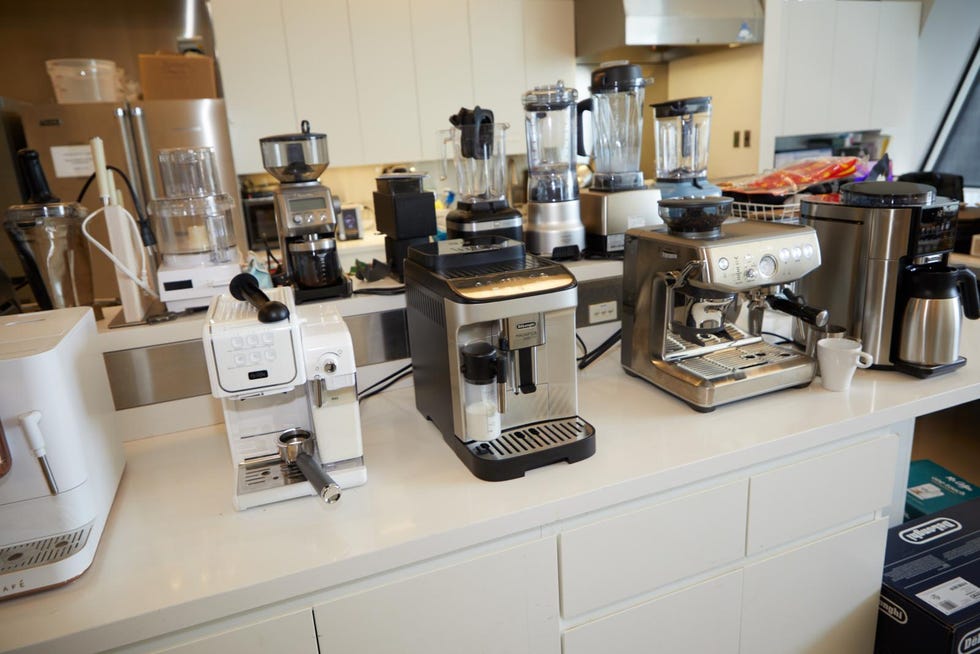 Kitchen counter featuring various coffee and blending appliances