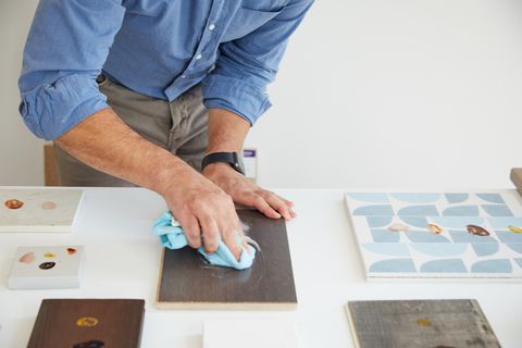 a good housekeeping expert performs stain testing on a variety of flooring samples