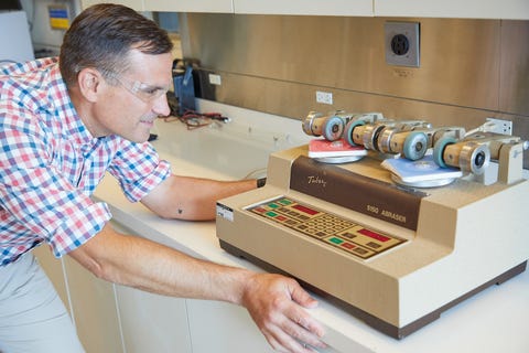 a tester uses an abrasion machine to measure paint durability