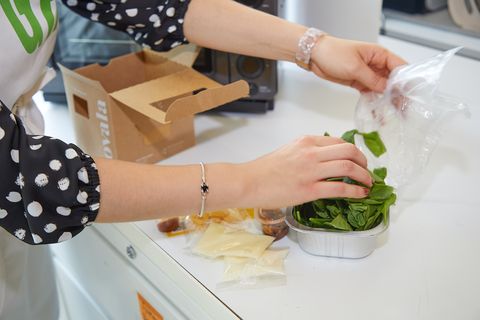good housekeeping expert testing out a meal delivery service and making a spinach salad