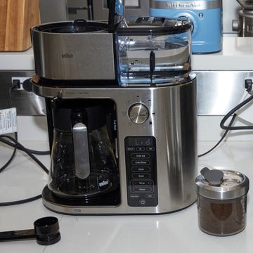 best dual coffee makers two coffee makers on a white countertop with coffee mugs and grounds beside the machines