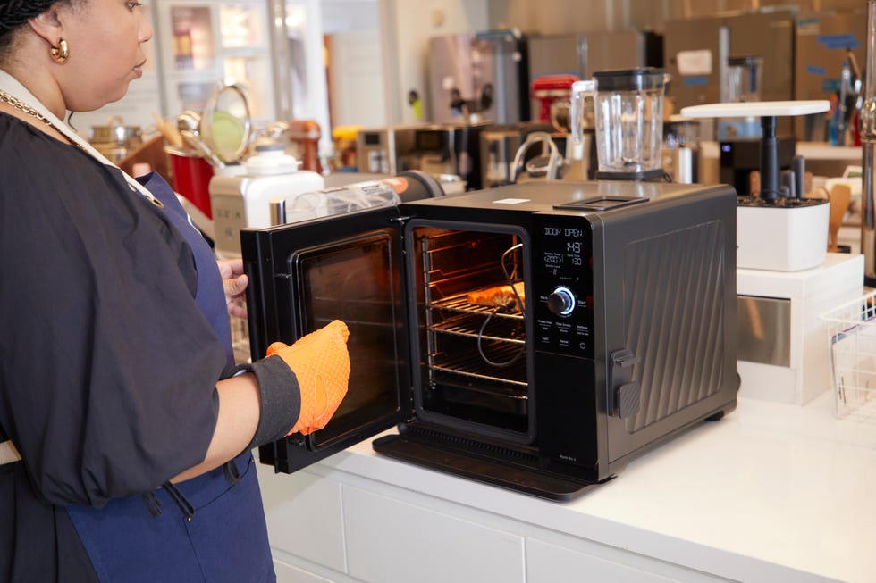 a person tending to a kitchen oven