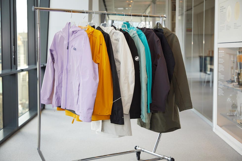 raincoats hanging on a coat rack in a hallway