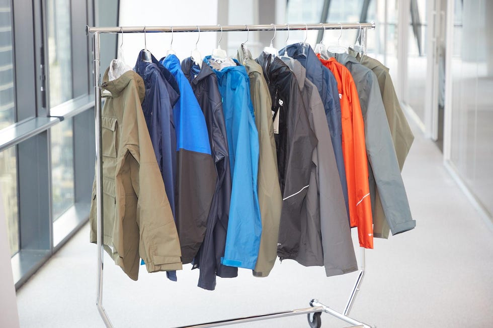 a rack of men's rain jackets in a hallway