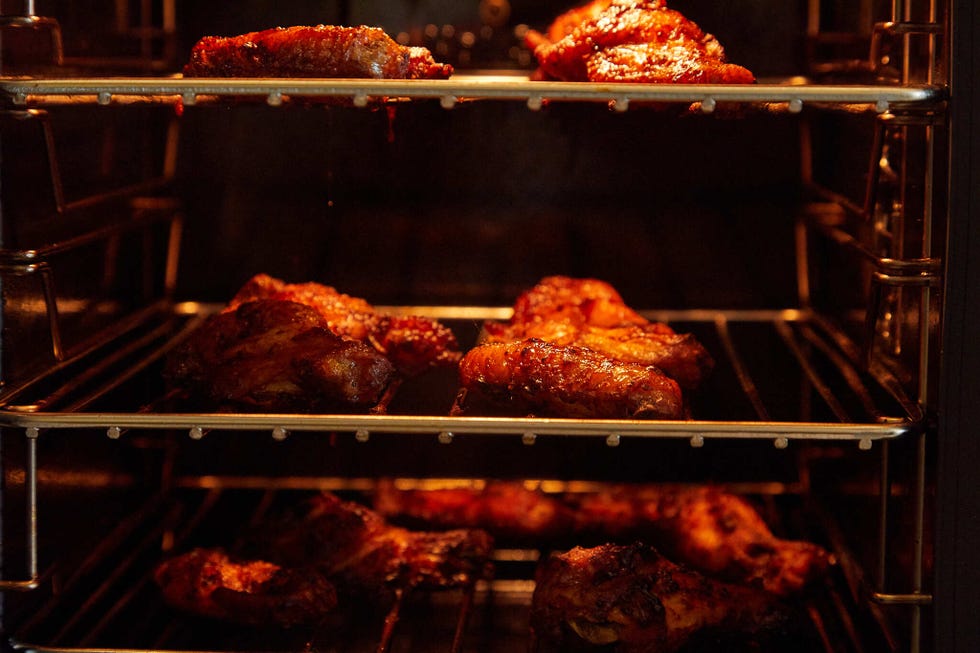 chicken pieces cooking in an oven
