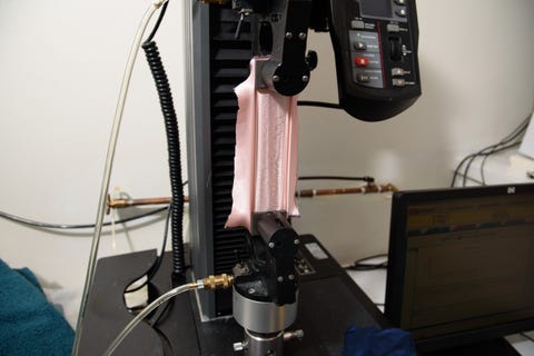 a pink silk pillowcase fabric in an instron machine, showing how the good housekeeping institute textiles lab tests fabric strength of silk pillowcases
