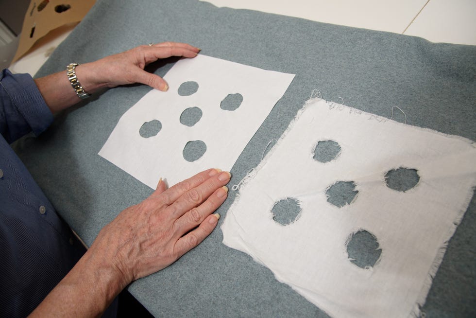 gh expert examines fabric swatches used in a washing machine gentleness test