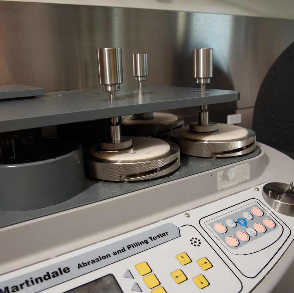 an image of the martindale abrasion tester at the good housekeeping institute's textiles lab, showing how good housekeeping tests to find the best silk pillowcase