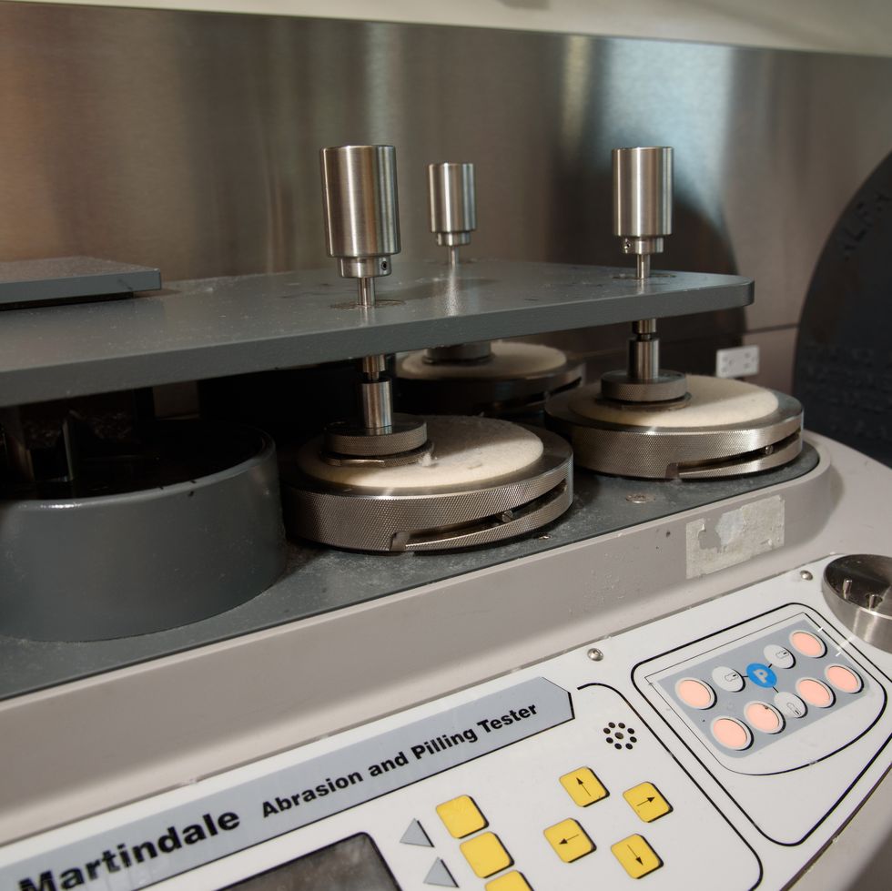 an image of the martindale abrasion tester at the good housekeeping institute's textiles lab, showing how good housekeeping tests to find the best silk pillowcase