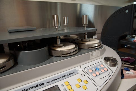 an image of the martindale abrasion tester at the good housekeeping institute's textiles lab, showing how good housekeeping tests to find the best silk pillowcase