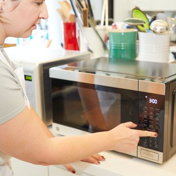 a person using a microwave