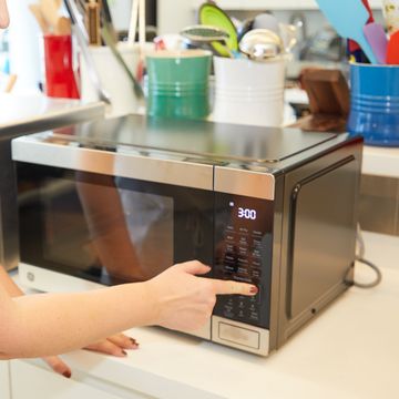 a person using a microwave