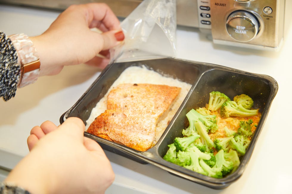 a person cutting a piece of bread