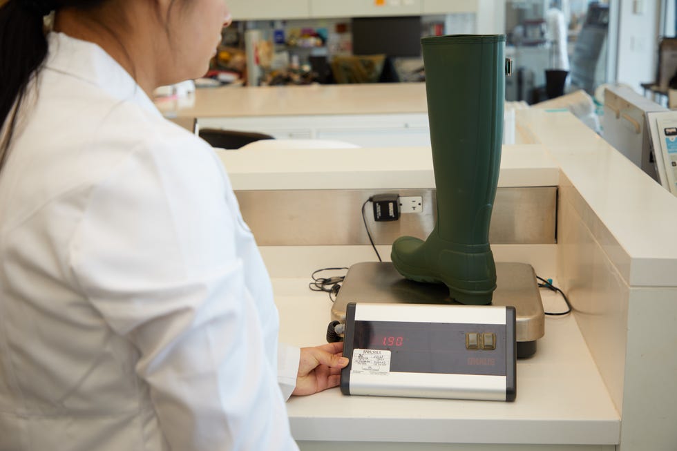 a good housekeeping analyst weighing a rain boot, testing for the best rain boots for women
